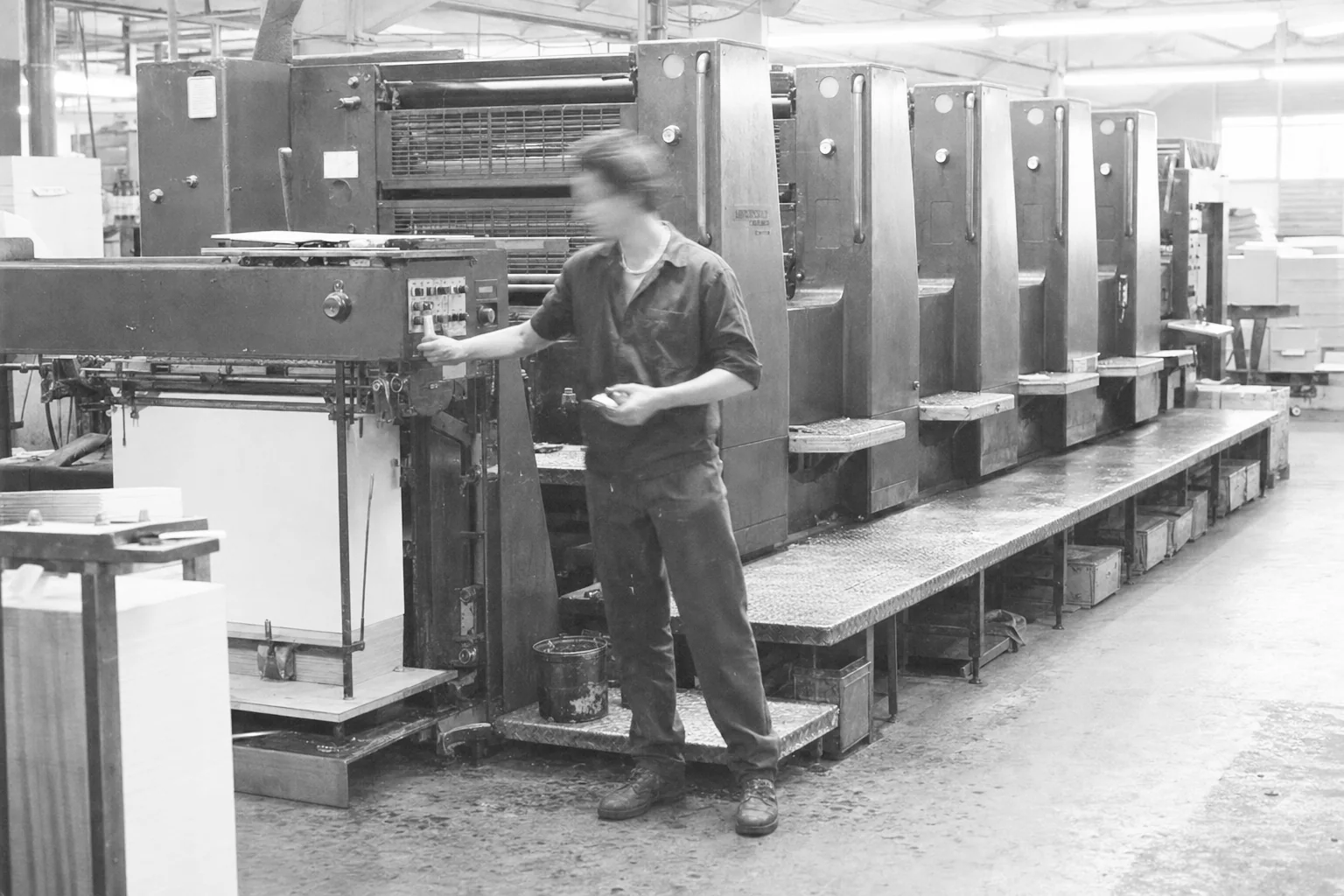 Operator working beside an offset printing press